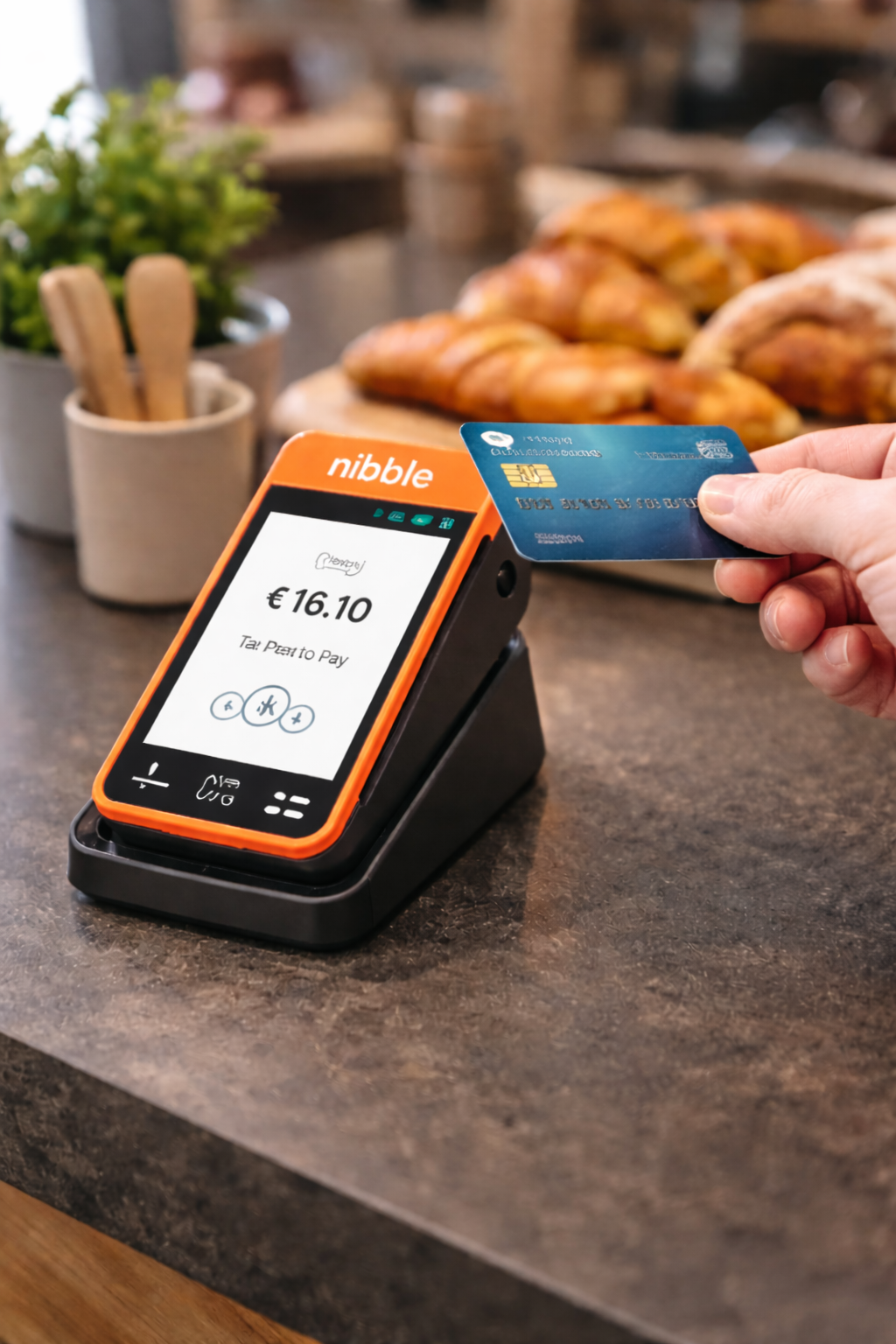 Customer tapping a contactless card on a Nibble POS terminal at a cafe counter